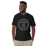 We're Still Here Tribal Listing Black Unisex T-shirt by Wayuką́