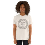 We're Still Here Tribal Listing Natural Unisex T-shirt by Wayuką́